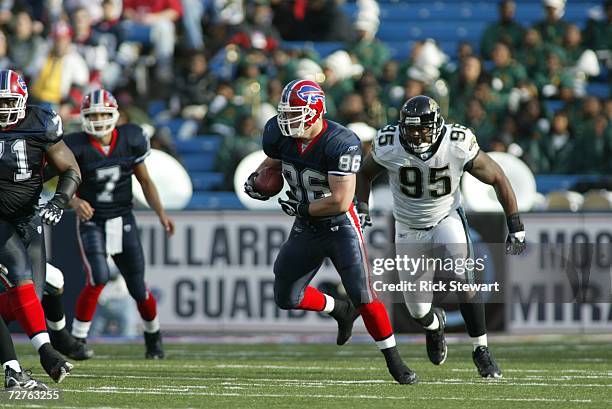 Tight end Brad Cieslak of the Buffalo Bills carries the ball against defensive end Paul Spicer of the Jacksonville Jaguars on November 26, 2006 at...