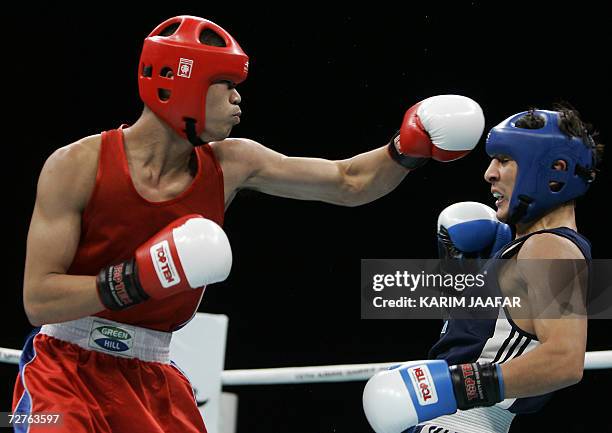 Galib Jafarov of Kazakistan fights with Anthony Marcial of Philppines during their 57kg boxing quarter-final bout at the 15th Asian Games in Doha in...