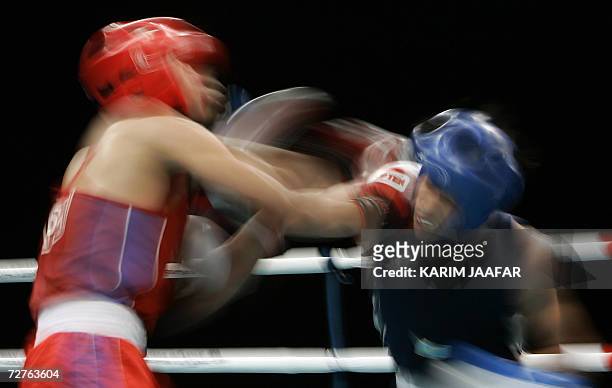 Galib Jafarov of Kazakistan fights with Anthony Marcial of Philppines during their 57kg boxing quarter-final bout at the 15th Asian Games in Doha in...