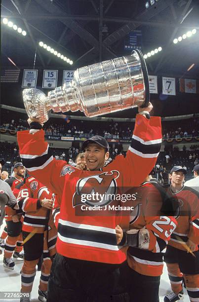 Canadian ice hockey player Martin Brodeur, goalkeeper for the New Jersey Devils, raises the Stanley Cup in celebration after his teams' victory in...