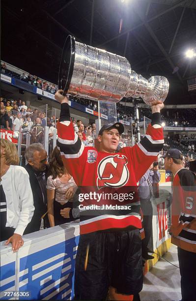 Czech ice hockey player Bobby Holik of the New Jersey Devils raises the Stanley Cup in celebration after his teams' victory in the finals, Dallas,...