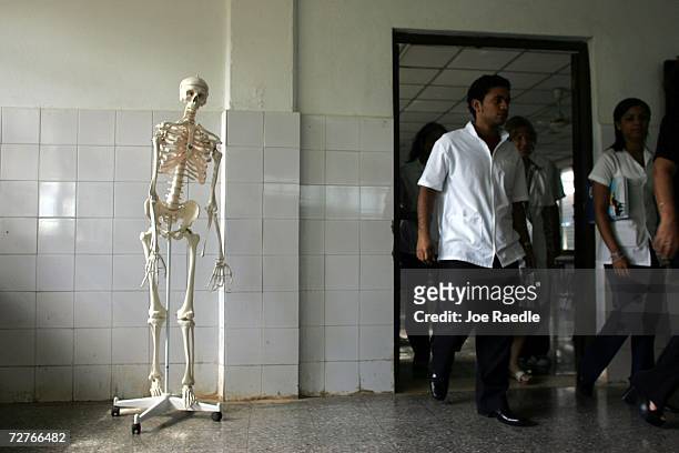 Medical students walk from a class room as they attend the Latin American School of Medical Sciences December 4, 2006 in Havana, Cuba. Students study...