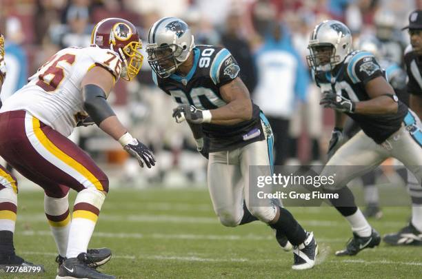 Julius Peppers of the Carolina Panthers guards the line during the game against the Washington Redskins on November 26, 2006 at FedEx Field in...