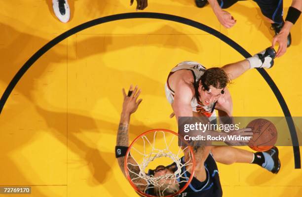 Troy Murphy of the Golden State Warriors takes the ball to the basket against Carlos Boozer of the Utah Jazz during a game at Oracle Arena on...