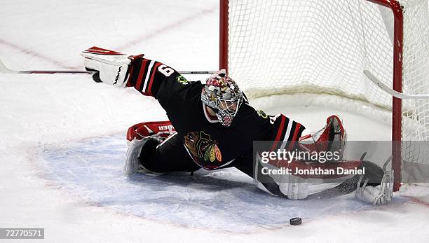 Goaltender Nikolai Khabibulin of the Chicago Blackhawks stretches to block a shot against the Phoenix Coyotes on December 7, 2006 at the United...