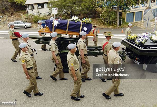 Coffin containing the body of Black Hawk helicopter pilot Captain Mark Bingley is carried away on the back of a gun carriage during his military...