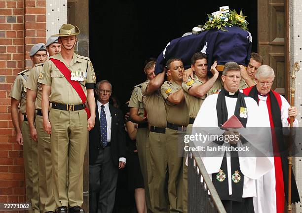 The coffin containing the body of Black Hawk helicopter pilot Captain Mark Bingley is carried down the stairs to the waiting gun carriage at the...