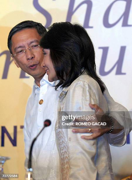 Ambassador Marciano Paynor, head of the national organizing committee holds Cebu Governor Gwendolyn Garcia after a press conference in Cebu...