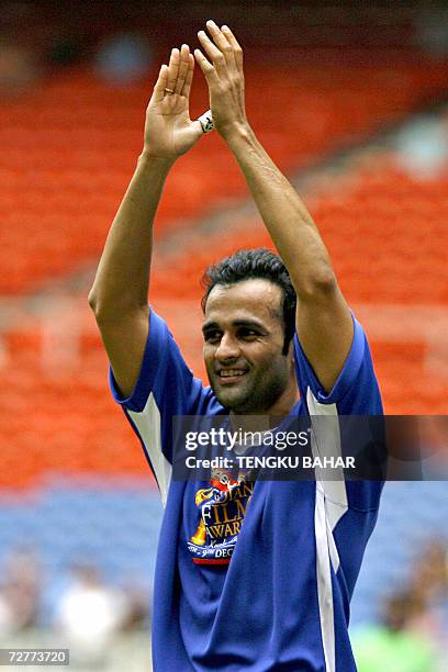 Kuala Lumpur, MALAYSIA: Bollywood film star Rohit Roy gestures to fans during a celebrity football match between Bollywood film stars and Malaysian...