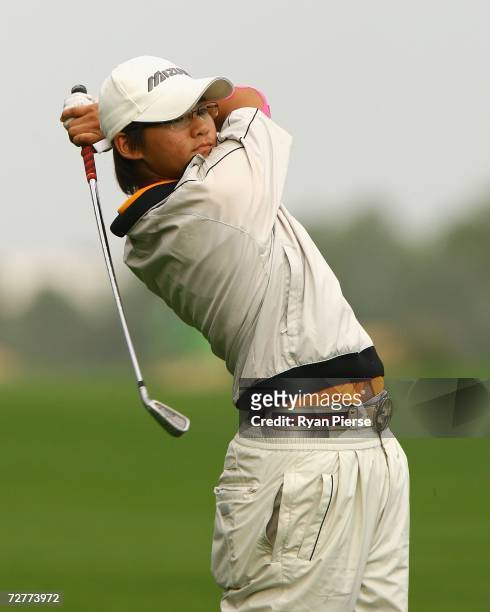 Tseng Ya Ni of Chinese Taipei hits an approach shot during round one of Women's Golf during day eight of the 15th Asian Games Doha 2006 at Doha Golf...