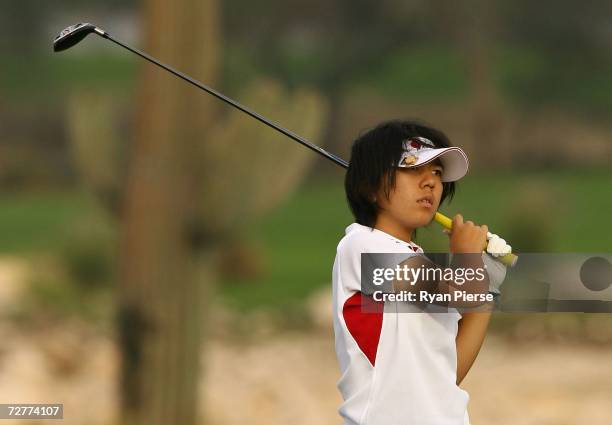 Nika Miyazato of Japan hits an approach shot during round one of Women's Golf during day eight of the 15th Asian Games Doha 2006 at Doha Golf Club on...