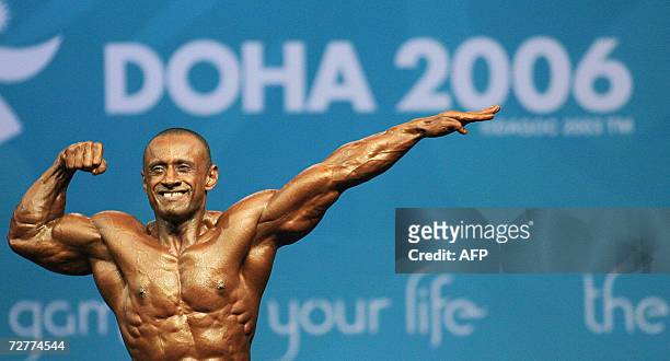 Omani body builder Said Nasser al-Maskari shows his muscles during the final of bodybuilding competition for 65 kgs 08 December 2006 at Al-Dana Hall...