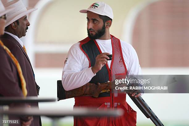 Sheikh Saeed Al Maktoum of the United Arab Emirates talks with the referees during the Men's Shooting Skeet final at the 15th Asian Games in Doha 08...