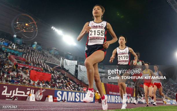 Japan's Kayoko Fukushi leads compatriot Hiromi Ominami in the women's 10,000m finals on the opening day of the athletes competition of the 15th Asian...