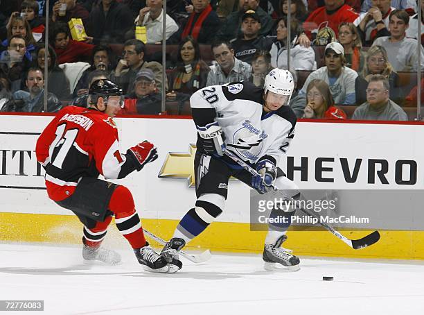 Vaclav Prospal of the Tampa Bay Lightning dekes around Daniel Alfredsson of the Ottawa Senators during a game on December 2, 2006 at the Scotiabank...