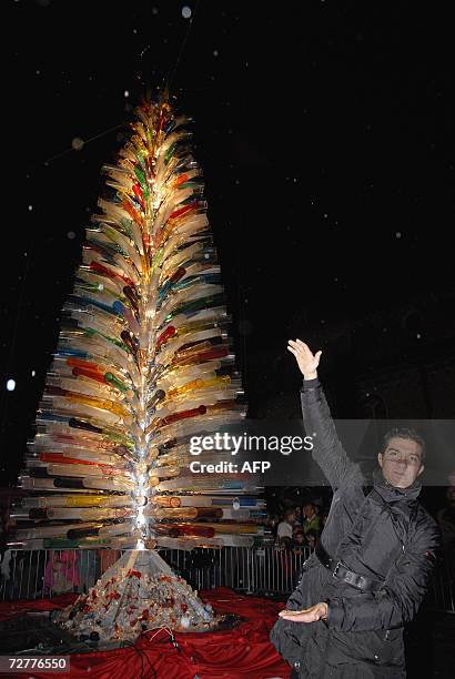 Venetian artist glass master Simone Cenedese poses in front of his creation, A glass Christmas tree , claimed to be the world's biggestplaced in the...