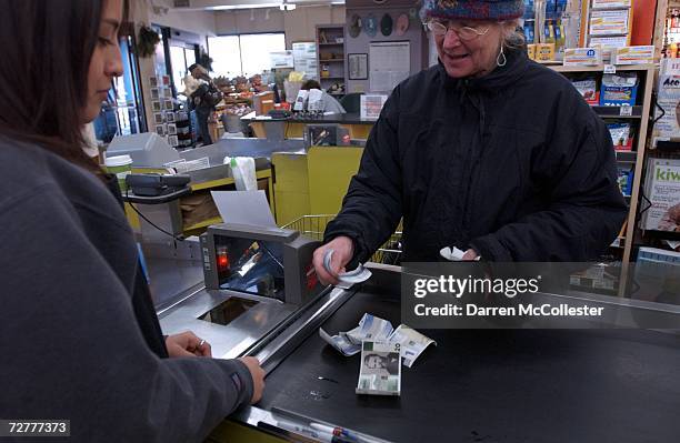 Beth Skinner counts out BerkShares to pay for her goods December 8, 2006 at Bershire Co-op Market in Great Barrington, Massachusetts. BerkShares are...