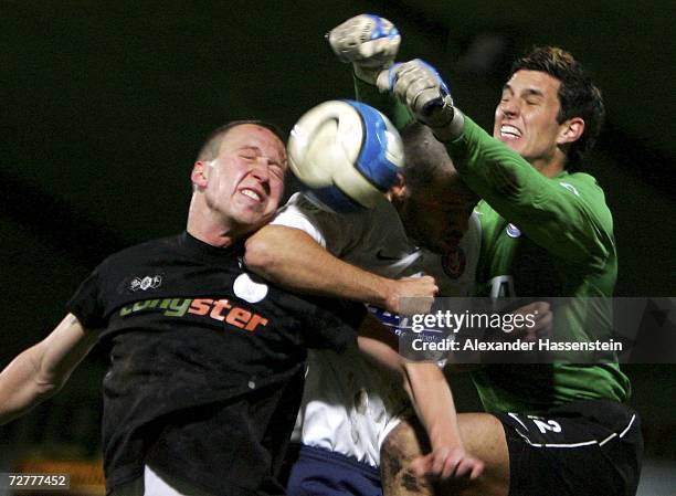 Marcel Eger of St. Pauli, Dirk Heinzmann and Manuel Lenz of Wuppertal challenge for the ball during the Third League match between FC St.Pauli and...