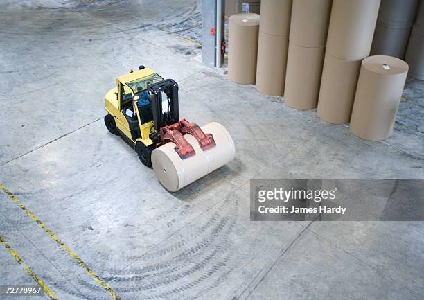 fork lift picking up roll of paper - paper mill stock pictures, royalty-free photos & images