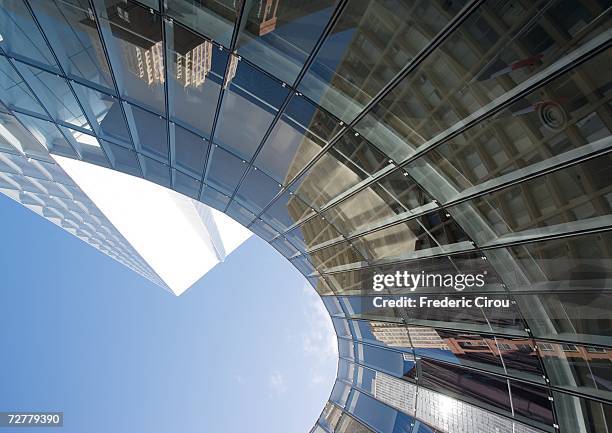 skyscraper with reflection of buildings on facade, low angle, abstract view - architecture close up stock pictures, royalty-free photos & images