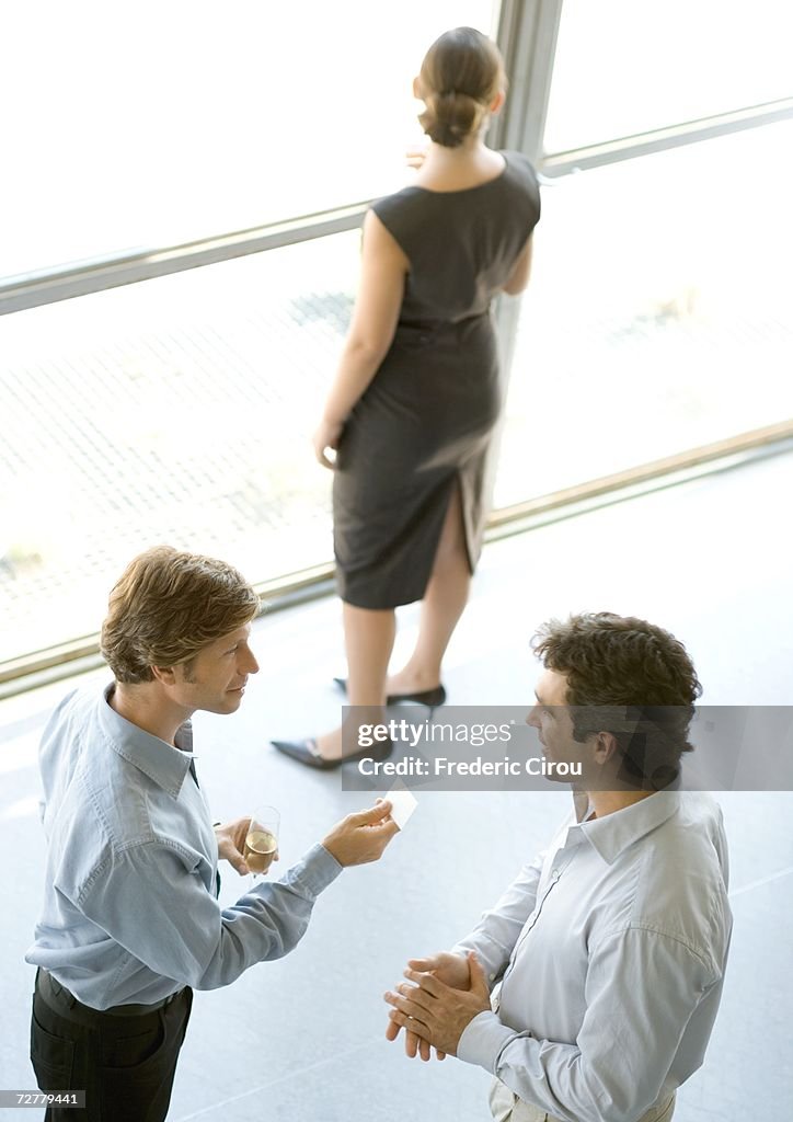 Executives exchanging business card during cocktail party