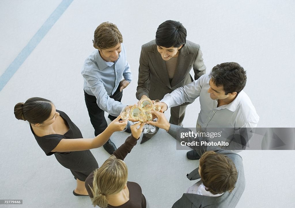 Executives making a toast during cocktail party, high angle view