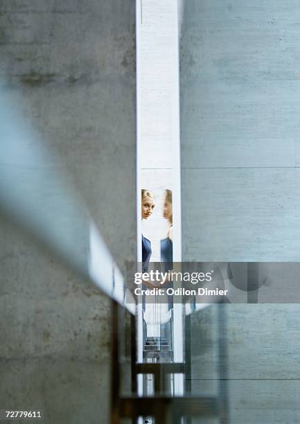 woman seen through narrow opening, with reflection - peeking over stock pictures, royalty-free photos & images