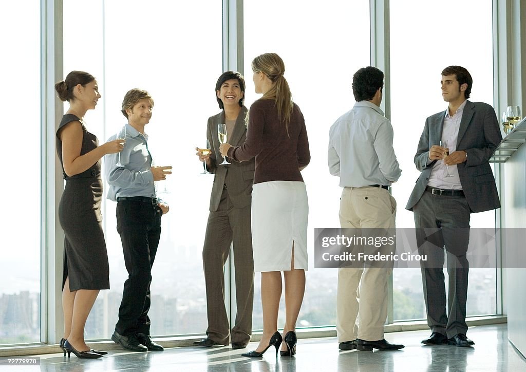 People standing with glasses during office party