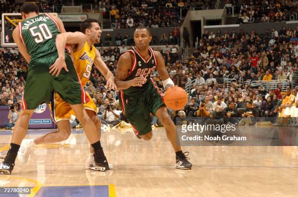 Dan Gadzuric of the the Milwaukee Bucks sets a pick on Jordan Farmar of the Los Angeles Lakers so Maurice Williams of the Bucks can drive to the...