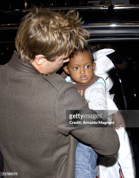 Actor Brad Pitt holds Zahara while leaving a toy store on 57th Street December 8, 2006 in New York City.