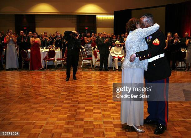 Lourdes German dance with her son Merlin German of New York while at a Brooke Army Medical Center holiday ball on December 8, 2006 in San Antonio,...