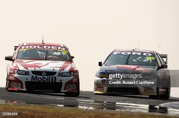 Mark Skaife of the Holden Racing Team holds off Craig Lowndes of Triple Eight Race Engineering during race one of round 13 of the V8 Supercars at the...