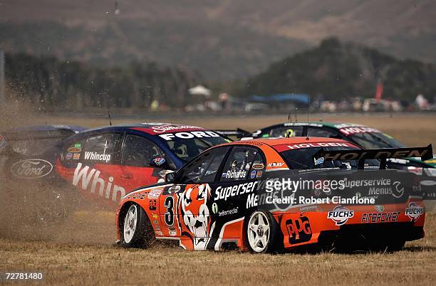 Jason Rochards of the Tasman Motorsport Team and Jamie Whincup of Triple Eight Race Engineering spin at the start during race one of round 13 of the...