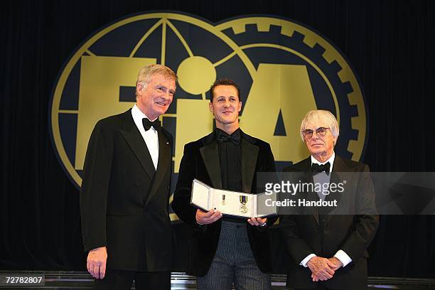 President Max Mosley and FOM President Bernie Ecclestone present Michael Schumacher with the FIA Academy Gold Medal at the 2006 FIA Gala Prize Giving...