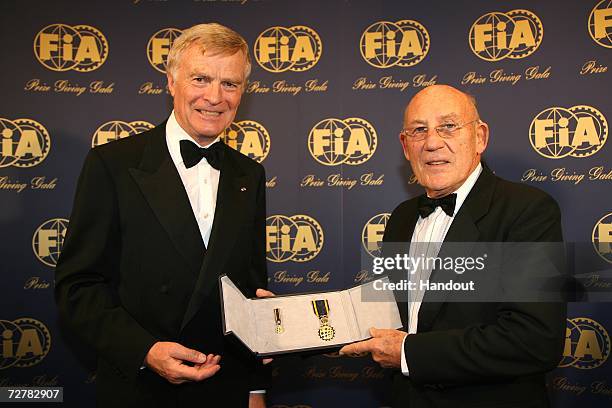 President Max Mosley presents Sir Stirling Moss with the FIA Academy Gold Medal at the 2006 FIA Gala Prize Giving Ceremony held at the Salle des...