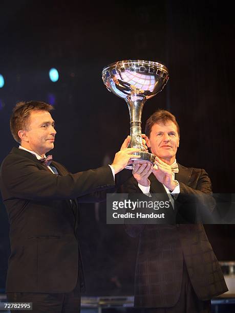 Jost Capito and Malcolm Wilson of Ford stand onstage with the FIA World Rally Championship Manufacturers trophy at the 2006 FIA Gala Prize Giving...