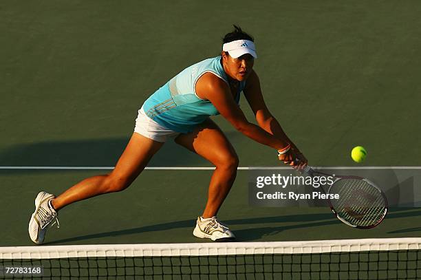 Tamarine Tanasugarn of Thailand hits a volley during her First Round Singles match against Akgul Amanmuradova of Uzbekistan during day nine of the...