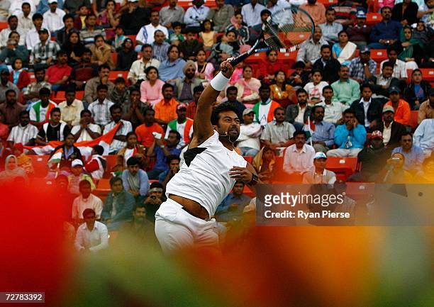 Leander Paes of India plays a smash during his First Round Mixed Doubles match with Sania Mirza of India against Murad Inoyatov and Dilyara...