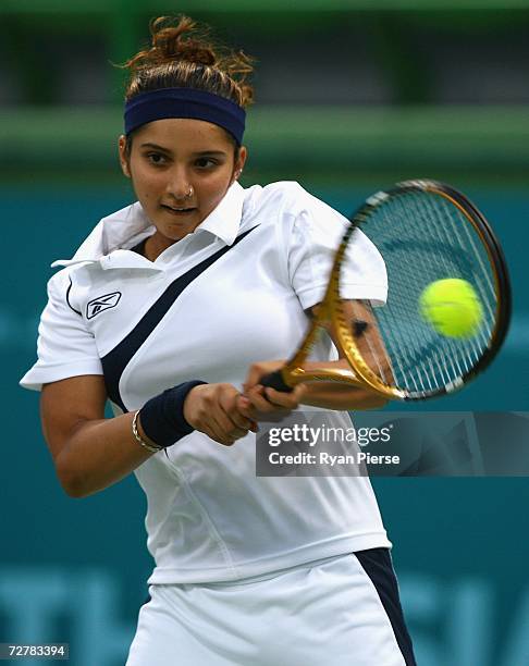 Sania Mirza of India plays a backhand during her First Round Mixed Doubles match with Leander Paes of India against Murad Inoyatov and Dilyara...