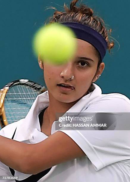 India's tennis player Sania Mirza returns a shot to Murad Inoyatov and Dilyara Saidhodjaeva of Uzbekistan during the Mixed Doubles - Round of 16...