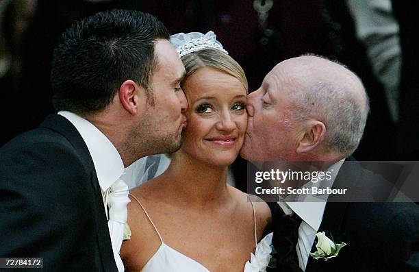 Actress Lucy Davis is kissed by her husband and actor Owain Yeoman and her father comedian Jasper Carrot after her wedding at St. Paul's Cathedral on...