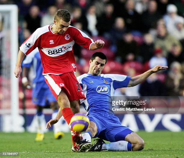 James Morrison of Middlesbrough is tackled by Paul Scharner of Wigan during the Barclays Premiership match between Middlesbrough and Wigan Athletic...