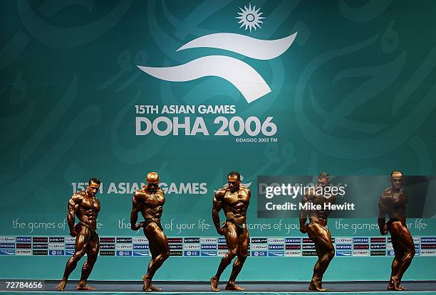 Competitors perform during the Men's over 90kg Finals of the Bodybuilding Competition at the 15th Asian Games Doha 2006 at the Al-Dana Banquet Hall...
