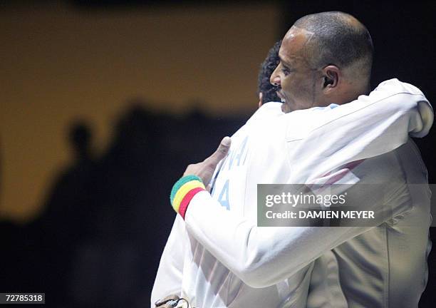 French swordsmen Laurent Lucenay and Jean-Michel Lucenay hug after the final of the French epee championship, 09 December 2006 at the Pierre de...