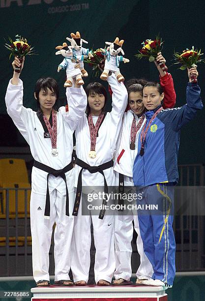 Silver winner Hoang Ha Giang of Vietnam, gold winner Kim Bo Hye of South Korea, and bronze winners Cosette Basbus of Lebanon and Saule Sardarova of...