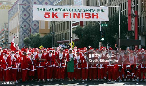 Runners dressed in Santa Claus outfits wait for the start of the second annual 5K Las Vegas Great Santa Run December 9, 2006 in Las Vegas, Nevada....