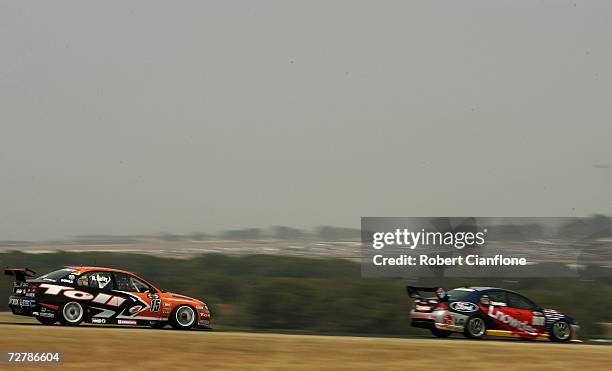 Rick Kelly of the Toll HSV Dealer Team chases down Craig Lowndes of Triple Eight Race Engineering during race two of round 13 of the V8 Supercars at...