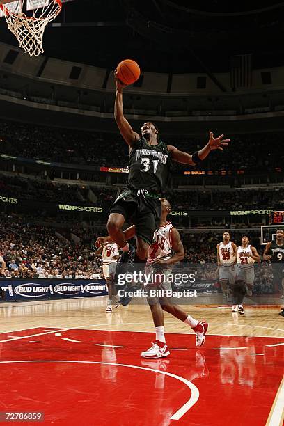 Ricky Davis of the Minnesota Timberwolves goes to the basket ahead of Ben Gordon of the Chicago Bulls during the NBA game on December 9, 2006 at the...