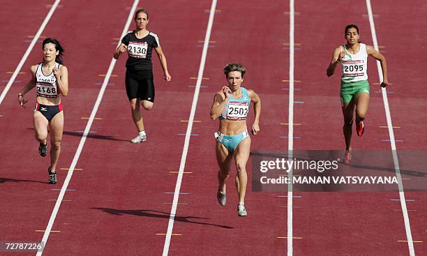 Uzbekistan's Guzel Khubbieva crosses the finish line ahead of Japan's Sakie Nobuoka , Abdul Razak Dana and India's Chitra Kulathummuriyil in the...