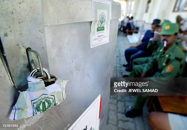 Banda Aceh, INDONESIA: Security personnel guard sealed ballot boxes at a polling station in Banda Aceh, 10 December 2006, a day before the provincial...